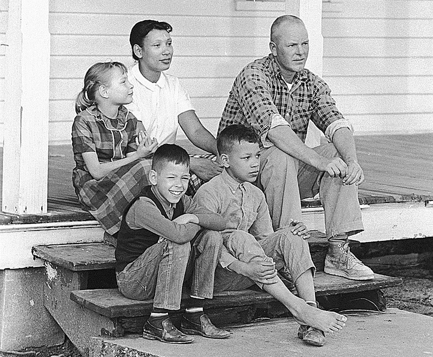 A black and white photograph depicting Richard and Mildred Loving at their home in Central Point, Va., with their children, from left, Peggy, Donald and Sidney, in 1967.