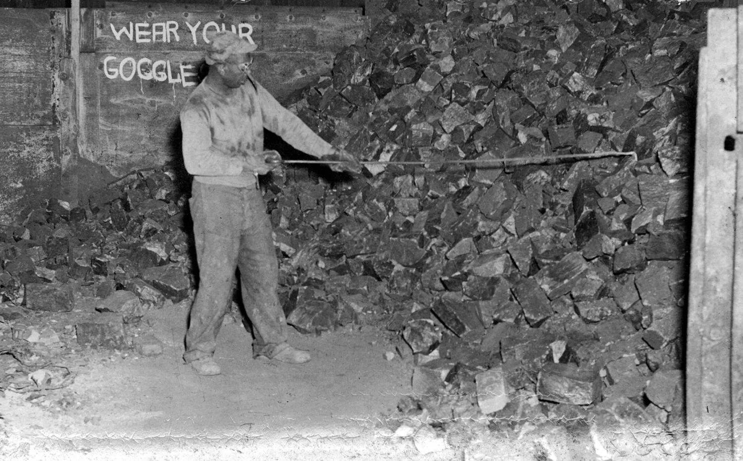 A black and white photograph of a Black steel worker at a Pittsburgh mill. Photo Source: Rivers of Steel Archives
