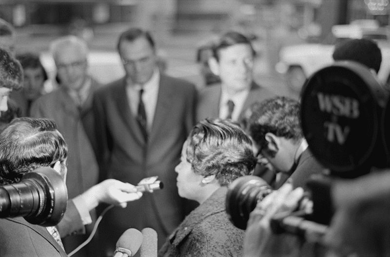 A black and white photograph of Dorothy Bolden, center, speaking with reporters at the National Conference of Mayors Meeting, 1971. Photo Source: Kenan Research Center