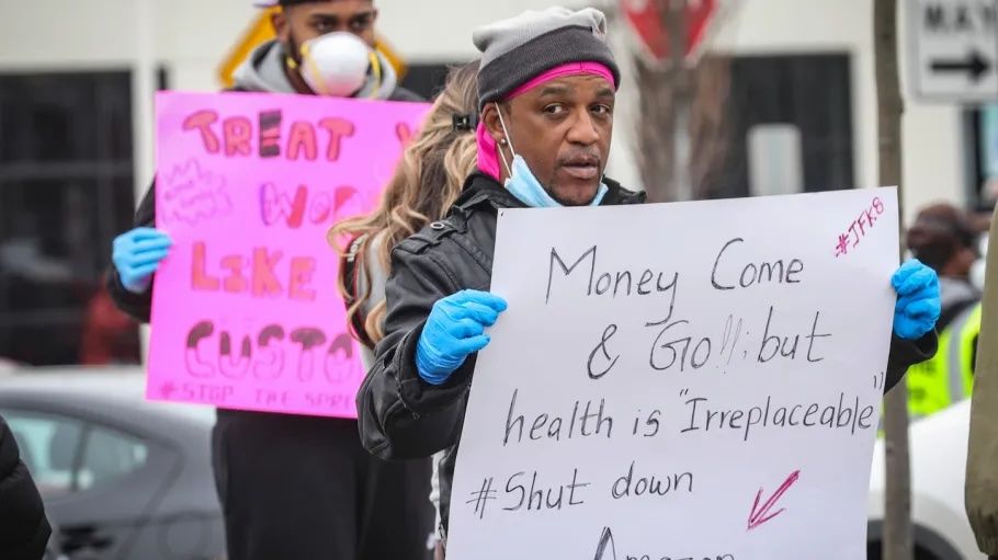 Photograph of Gerald Bryson, center, another leader of the March 2020 walkout, holding a sign that says “Money come and go, but health is irreplacable #shutdownamazon”. Photo Source: Sourcing Journal