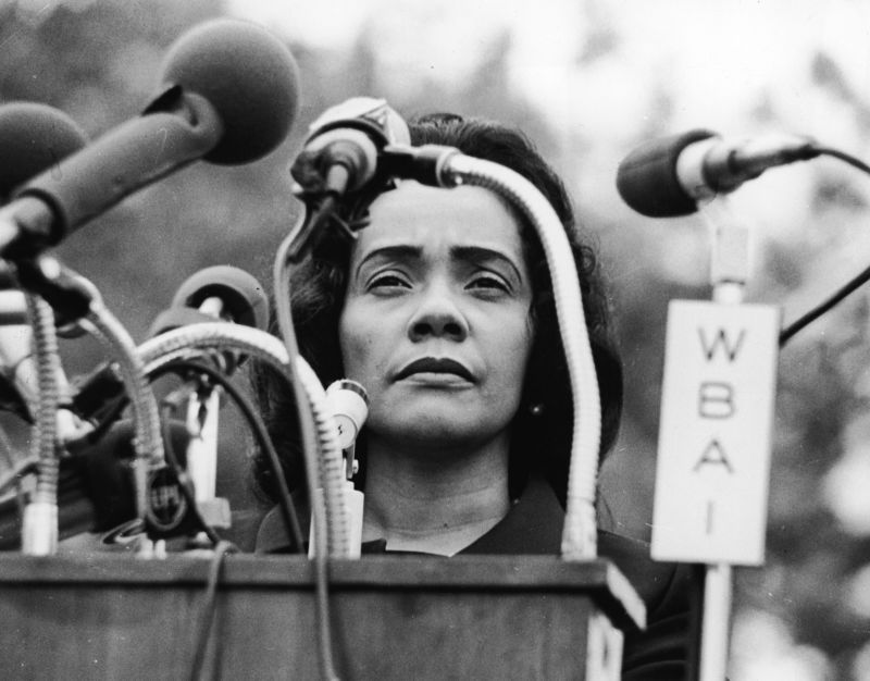A black and white photo of King, standing behind a podium covered in microphones at Peace-In-Vietnam Rally, Central Park, New York, April 27, 1968.. Photo Source: Hulton Archive/Getty Images