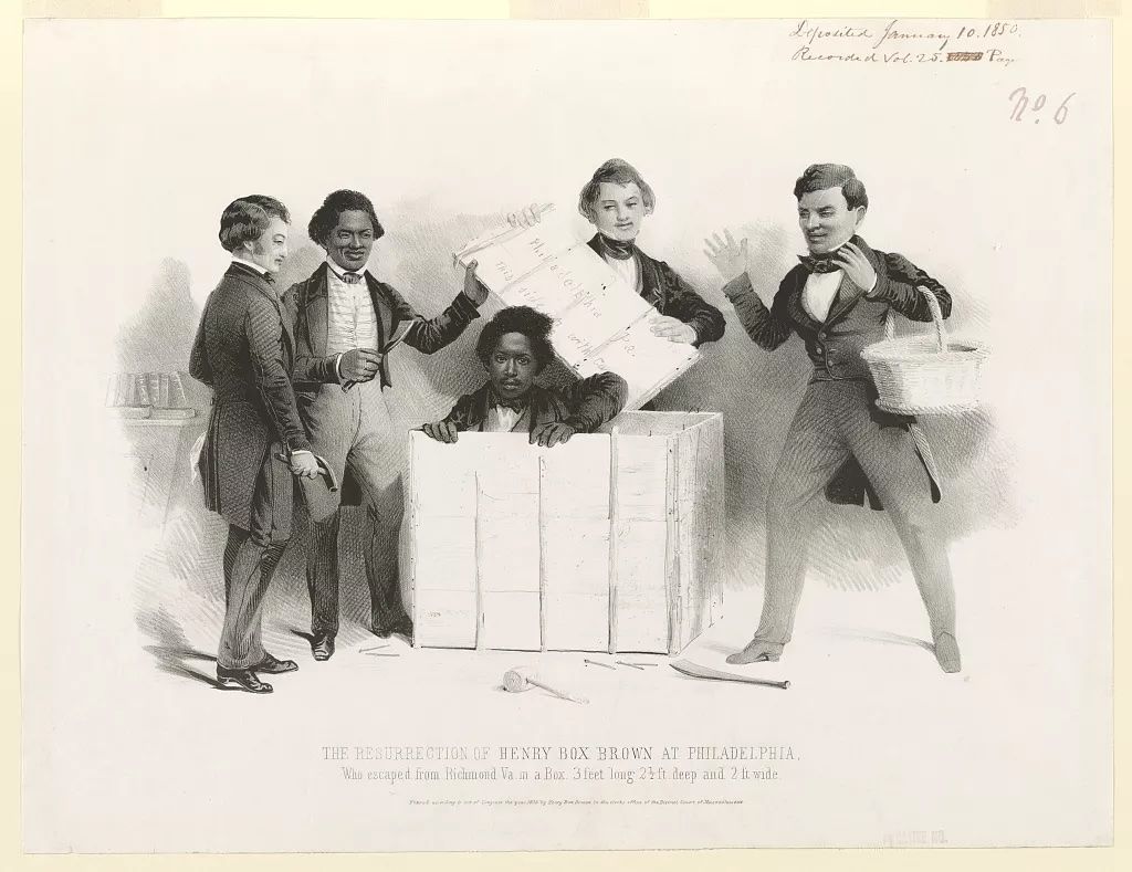 An engraving of four men, presumably those present when he arrived in Philadelphia, standing around a large box from which Brown is emerging, the tools for the removing the lid on the ground. Image So