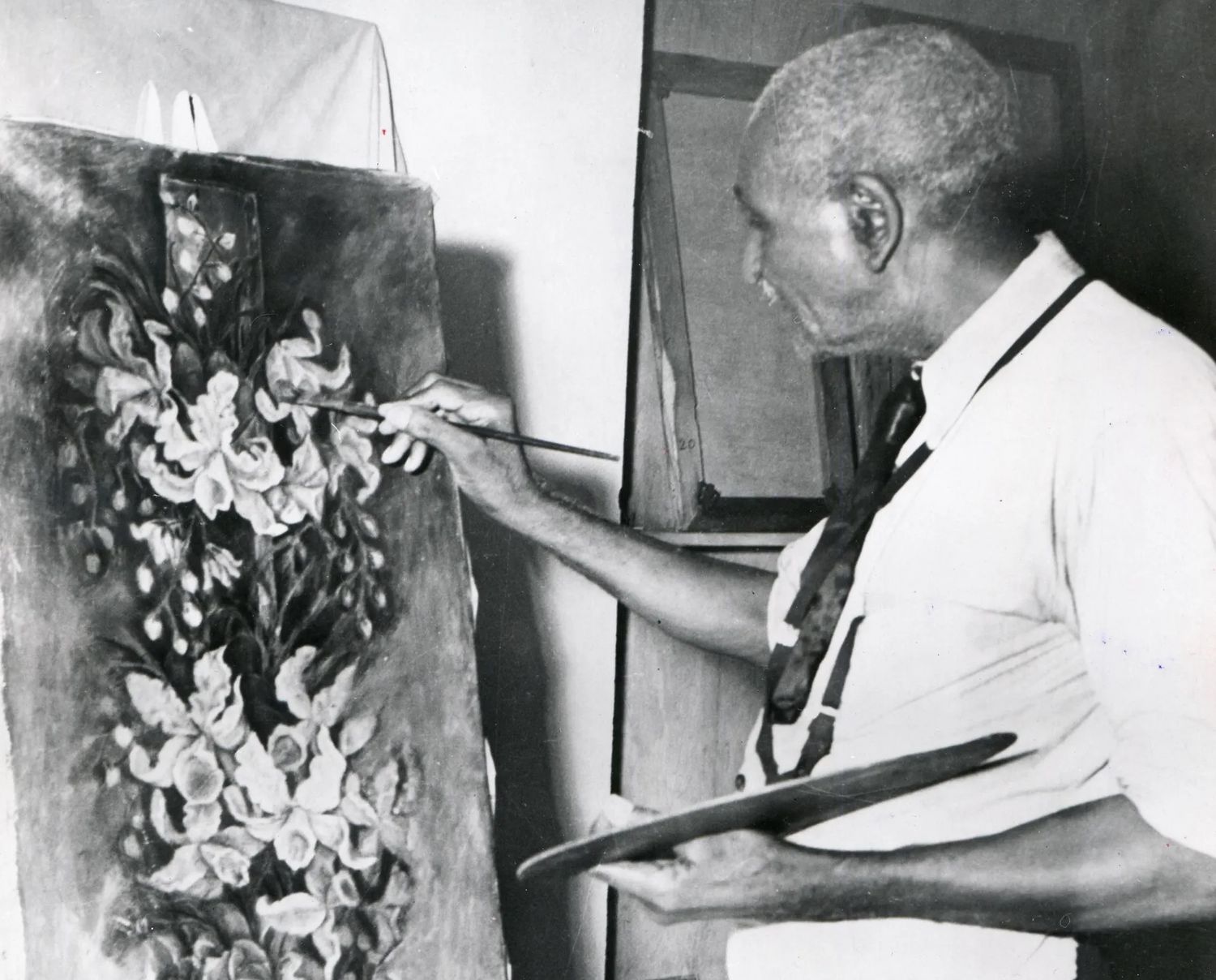 A black and white photo of Carver working on one of his last paintings, entitled "The Yucca.” Photo Source: Photoquest/Getty Images