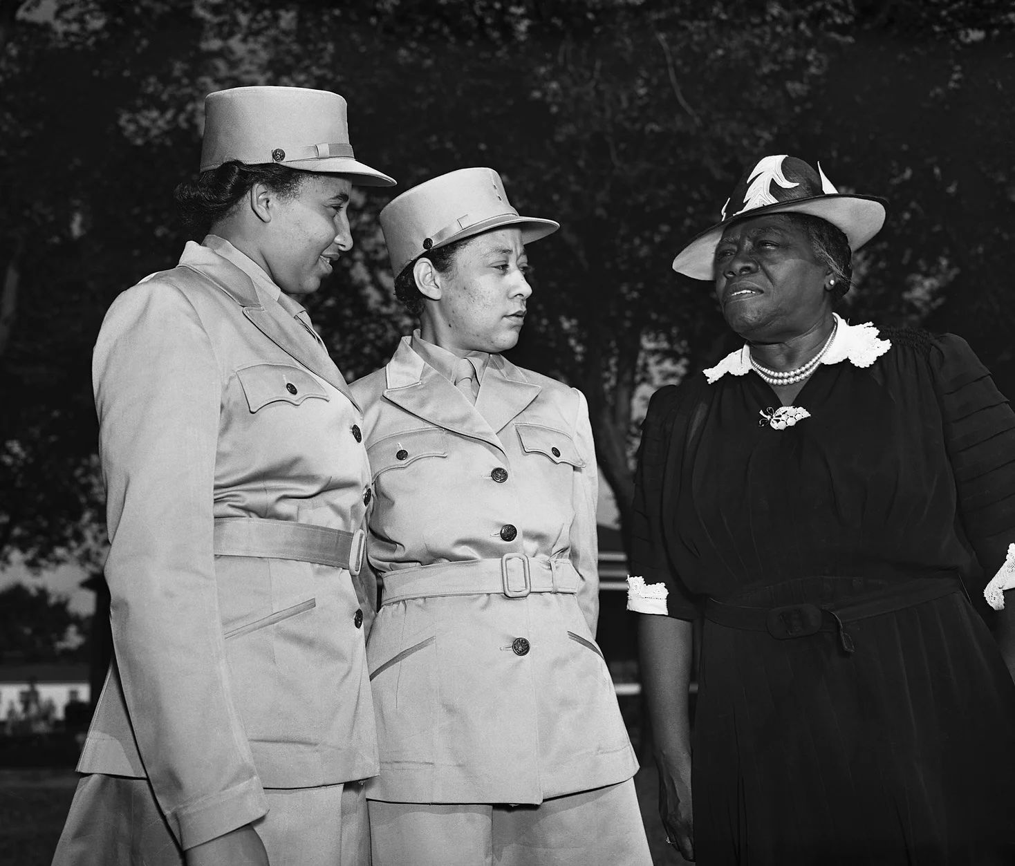 Mary McLeod Bethune (right) in conversation with Vera Harrison and Mary Bordeaux, women in the Women's Auxiliary Army Corps (WAAC) during a visit to Fort Des Moines, Iowa. Photo Source: Getty Ima
